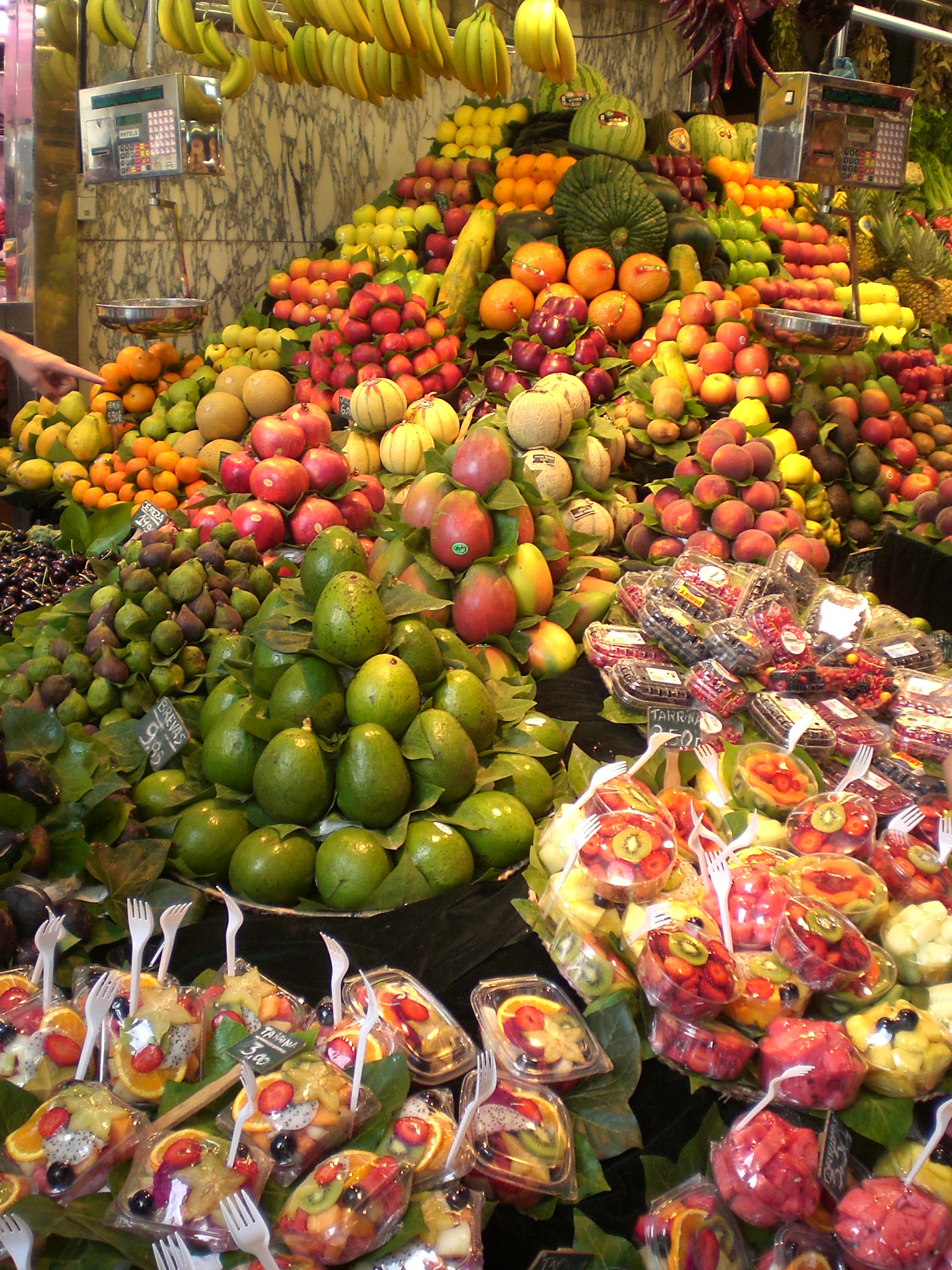 Colorful fruit and food stalls inside La Boqueria covered market Barcelona